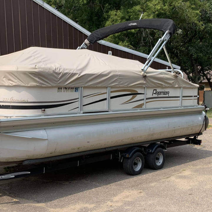 A pontoon with a light brown cover