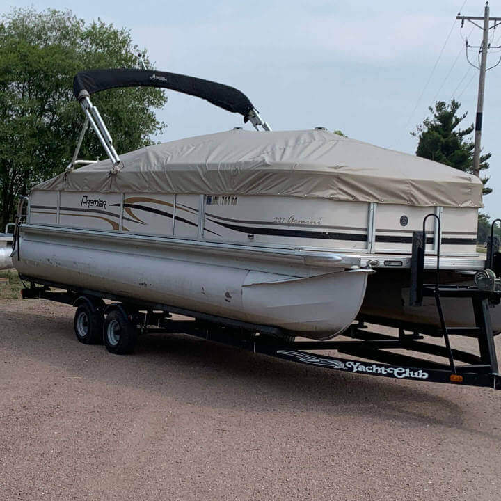 A pontoon with a late colored cover